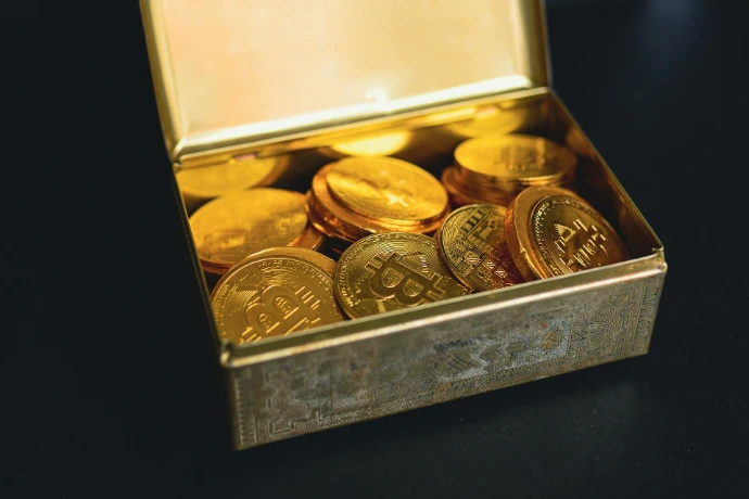a box of gold coins sitting on a table